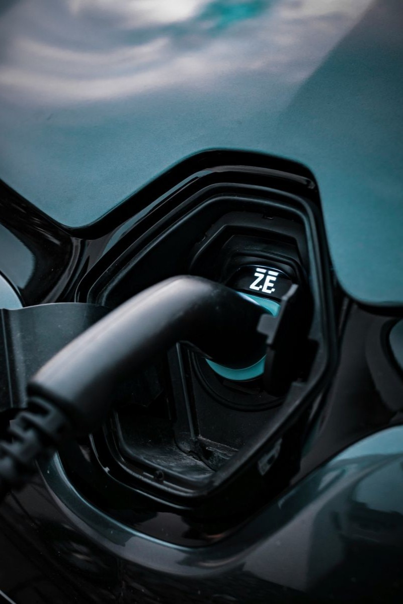 a person is charging a car with a green light